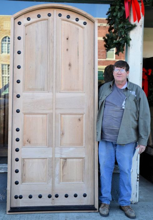 Roger Long stands next to one of the many doors that he has custom built for Southern Accents customers.